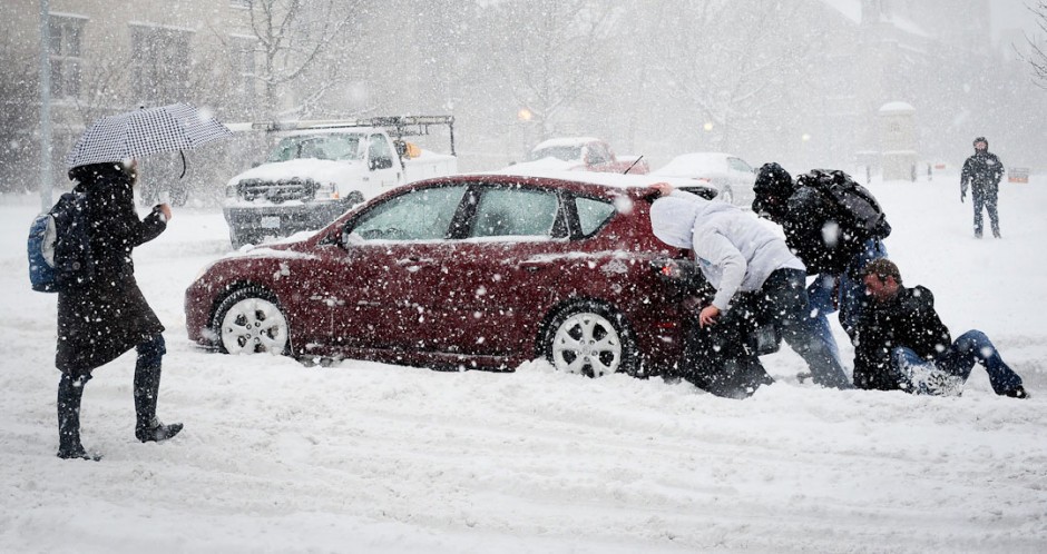 Students pushing car out of snow