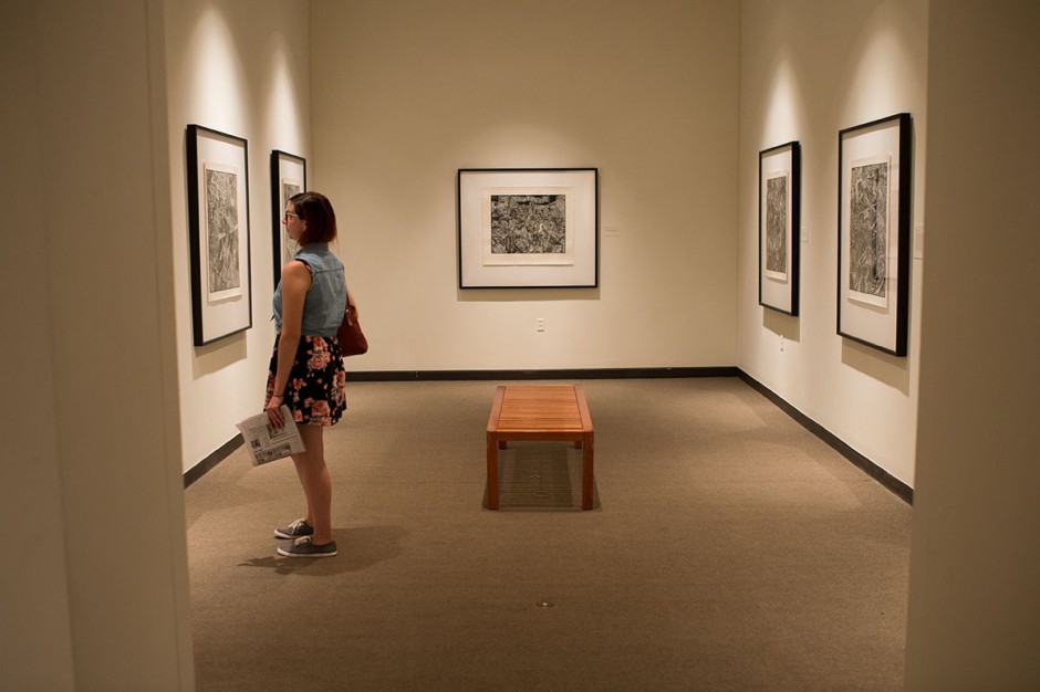 Woman looking at framed art.