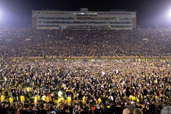 Fans running onto the football field.