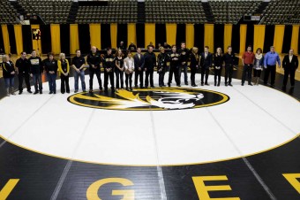 Students standing on wrestling mat.