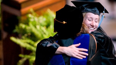 graduates hugging