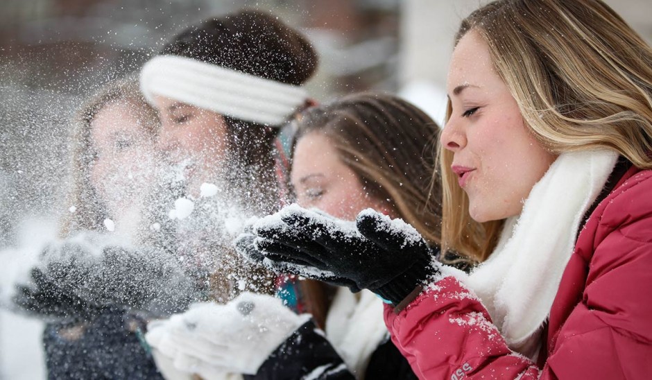 Girls blowing snow.