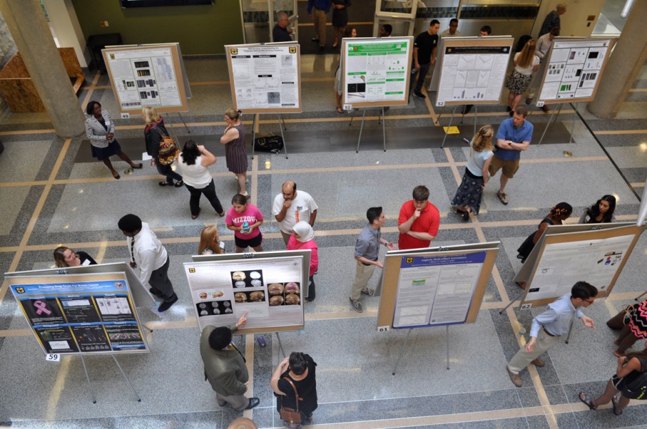 Aerial image of students looking at research posters.
