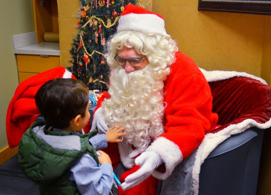 Child touching Santa's beard.