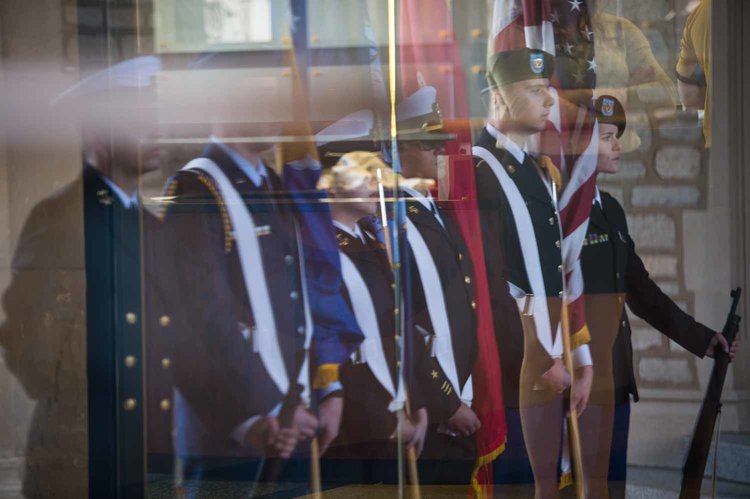 Members of Mizzou's ROTC are reflected in the glass doors under Memorial Union's archway.