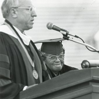 Lucille Bluford smiles as she is honored at a commencement ceremony.