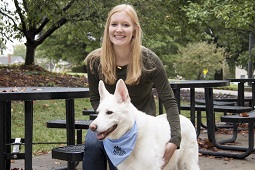This is a picture of Lauren Panasevich with a white dog