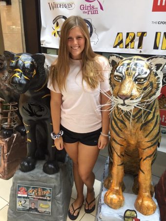 This is a picture of Jenna Heaton by a Tiger statue 