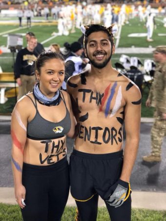 Picture of Naseer and a fellow Tiger's Lair member wearing body paint at a Mizzou Football game. 