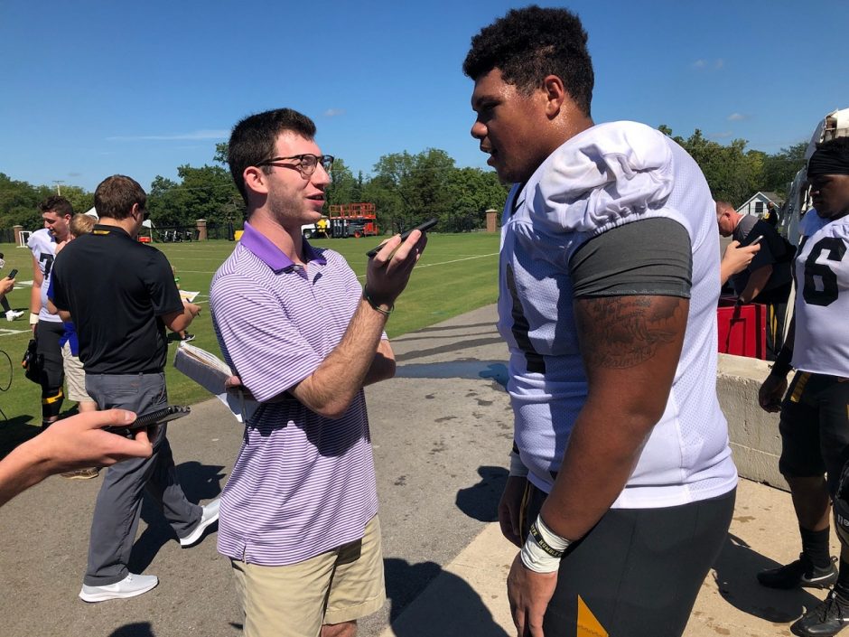 This is a picture of Alec Lewis interviewing Mizzou offensive lineman Kevin Pendleton during football practice