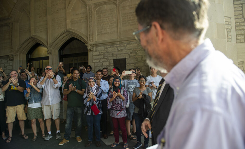 A cheering crowd of supporters greets Dr. Smith as he approaches Memorial Union where the celebration was held.