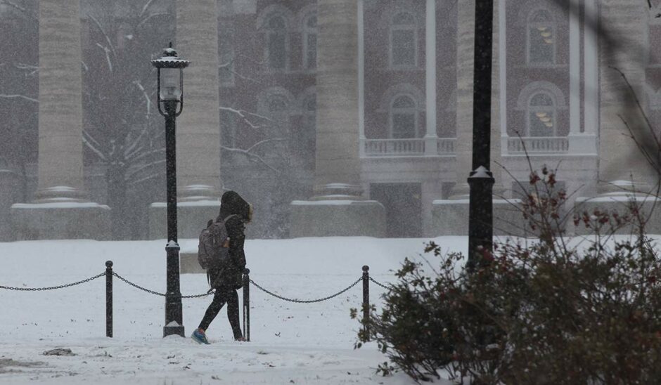 Student walks across snowy quad