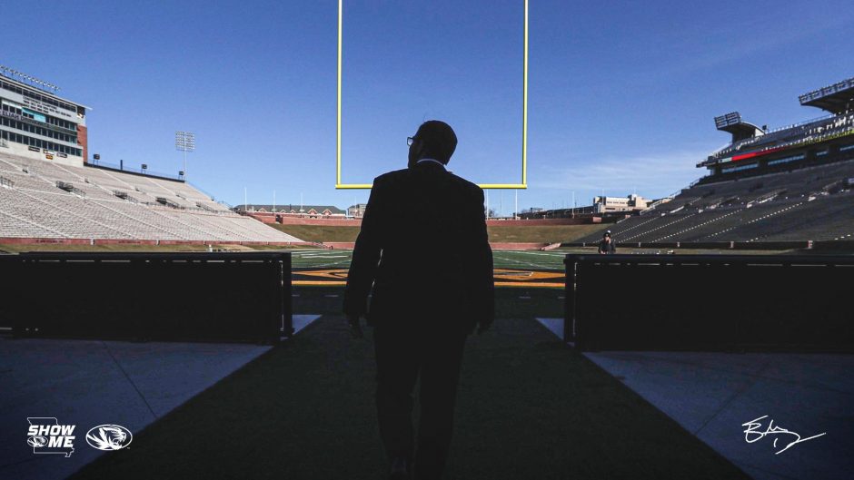 This is a picture of Eli Drinkwitz stepping onto Faurot Field