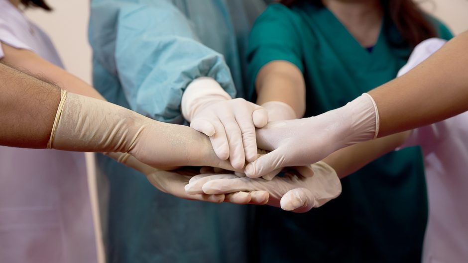 nurses with gloved hands