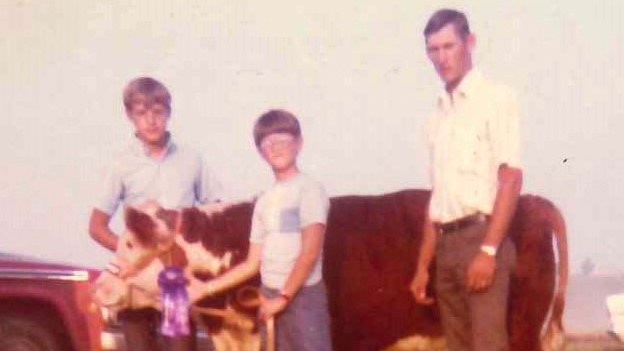 Mike Kateman, center, with his calf, Boots.