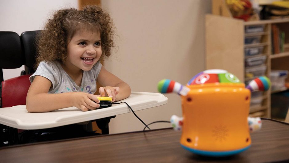 Claudia Stephens, 3, plays with Switched Adapted Toys at Children’s Therapy Center.