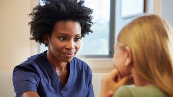Nurse Treating Teenage Girl Suffering With Depression