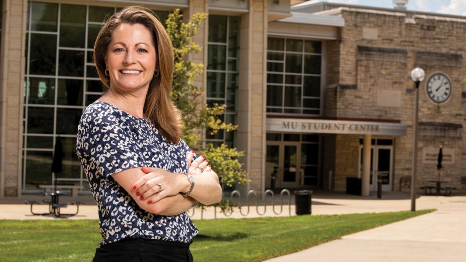 lori fox smiling in front of student center