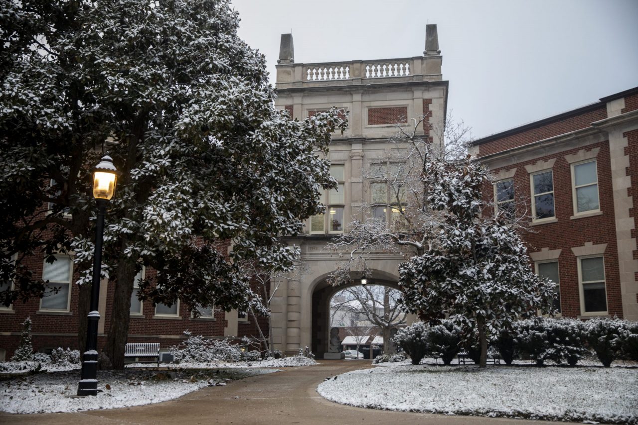Snow on the ground and trees outside the Journalism School archway between Neff Hall and Walter Williams Hall
