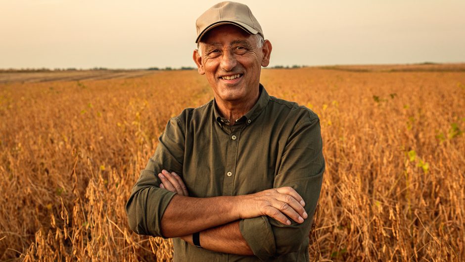 farmer in a field smiling