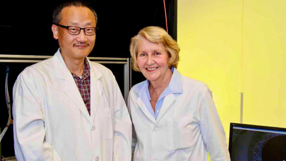 Gary Yao, professor of biomedical, biological and chemical engineering, and Judith Miles, professor emerita of child health and genetics. Note: This photo was taken prior to COVID-19.