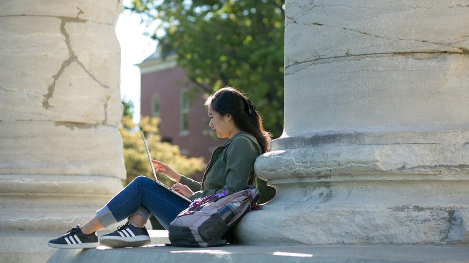 woman studying at the columns