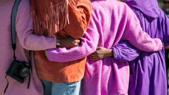 This is a photo of people with their arms around each other.