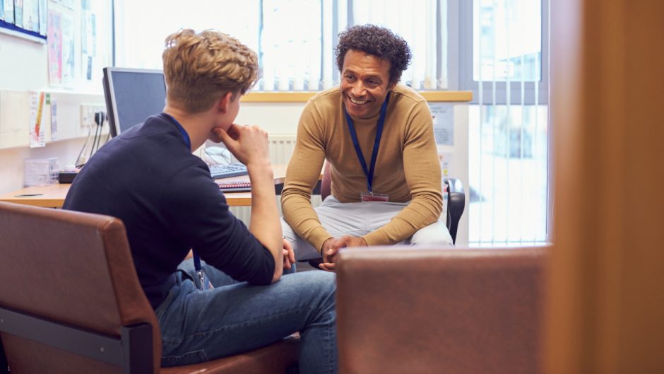 This is an image of a man talking to a student about his mental health. Source: Shutterstock