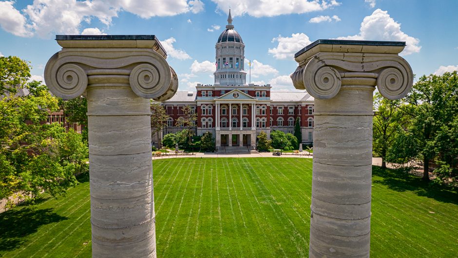 drone shot of jesse hall with two of the iconic columns close up at the front
