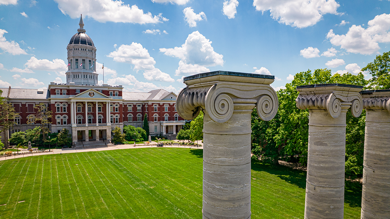 drone shot of jesse hall with the columns in detail on the right side of the photo