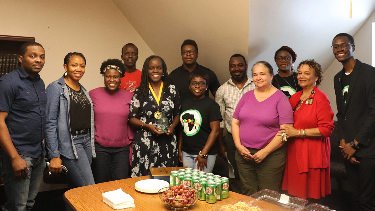 a group celebrating a woman receiving an award