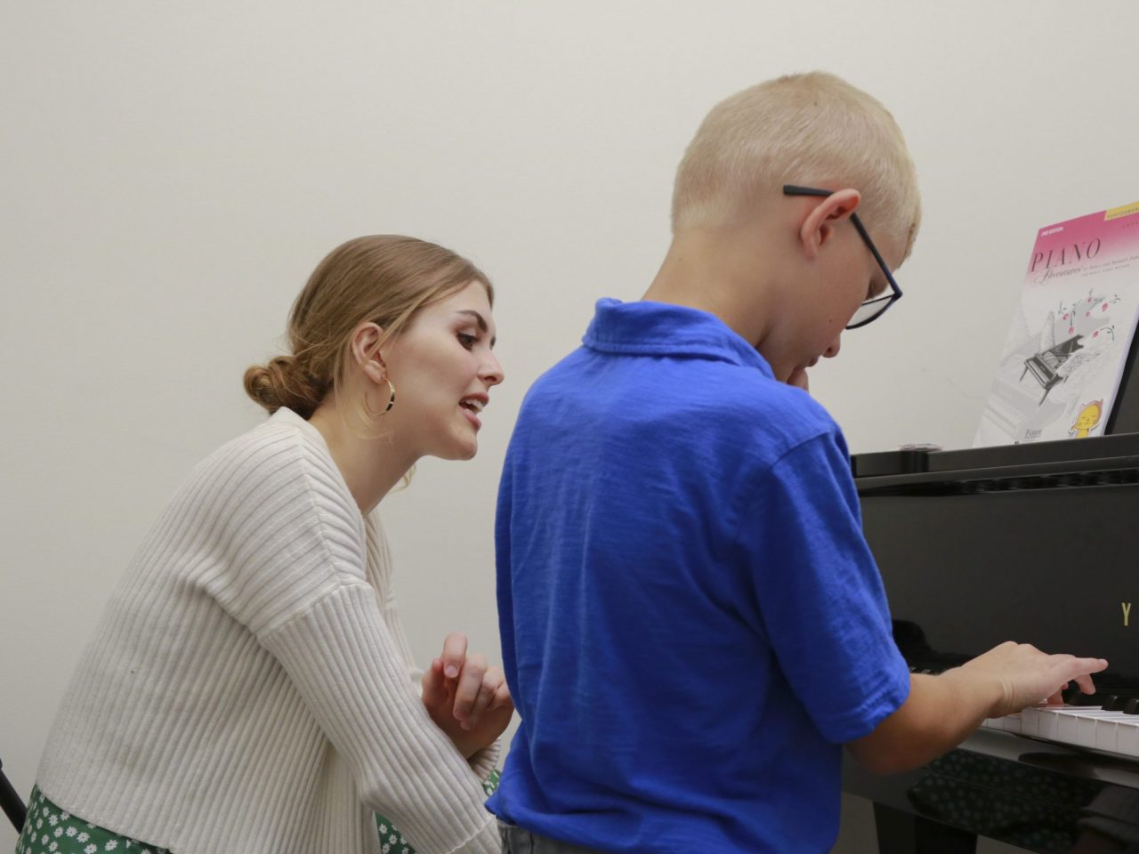 a teacher with a piano student