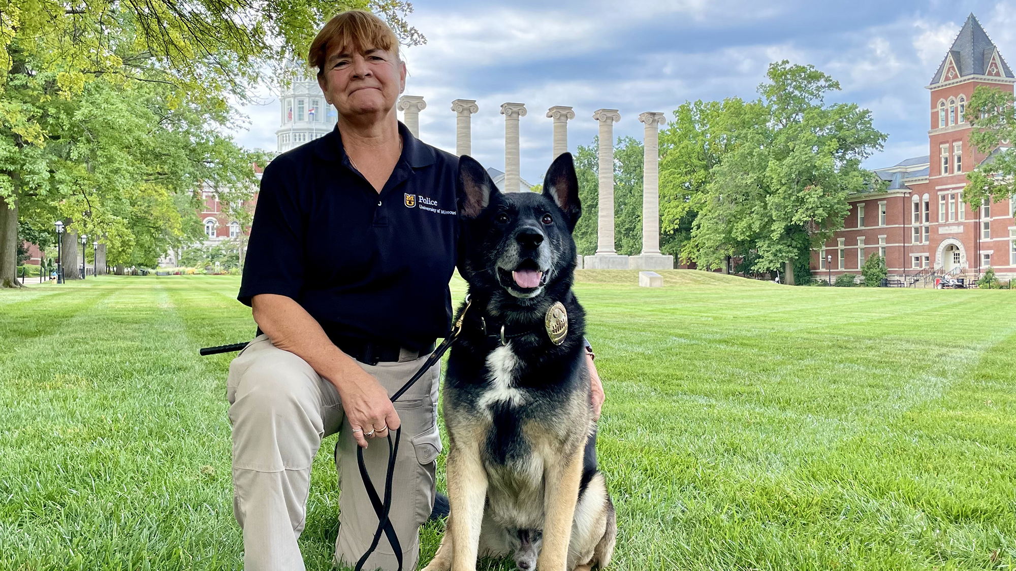 a german shepard and his handler on the quad