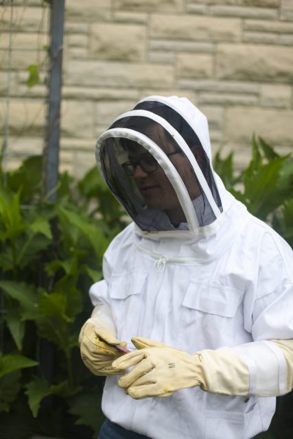this is a photo of someone in a beekeeping suit