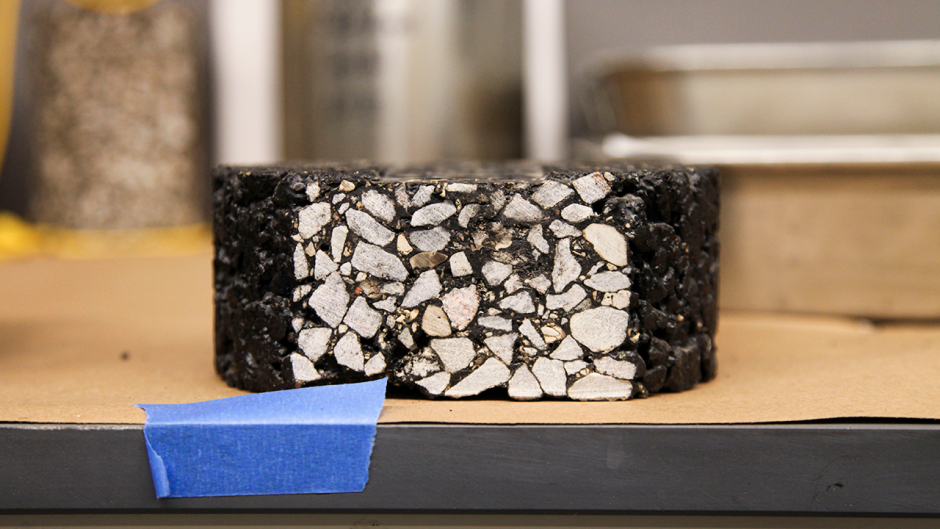 An asphalt pavement test mixture sample designed by the Mizzou Asphalt Pavement and Innovation Lab that is ready for further testing to determine its strength and durability.