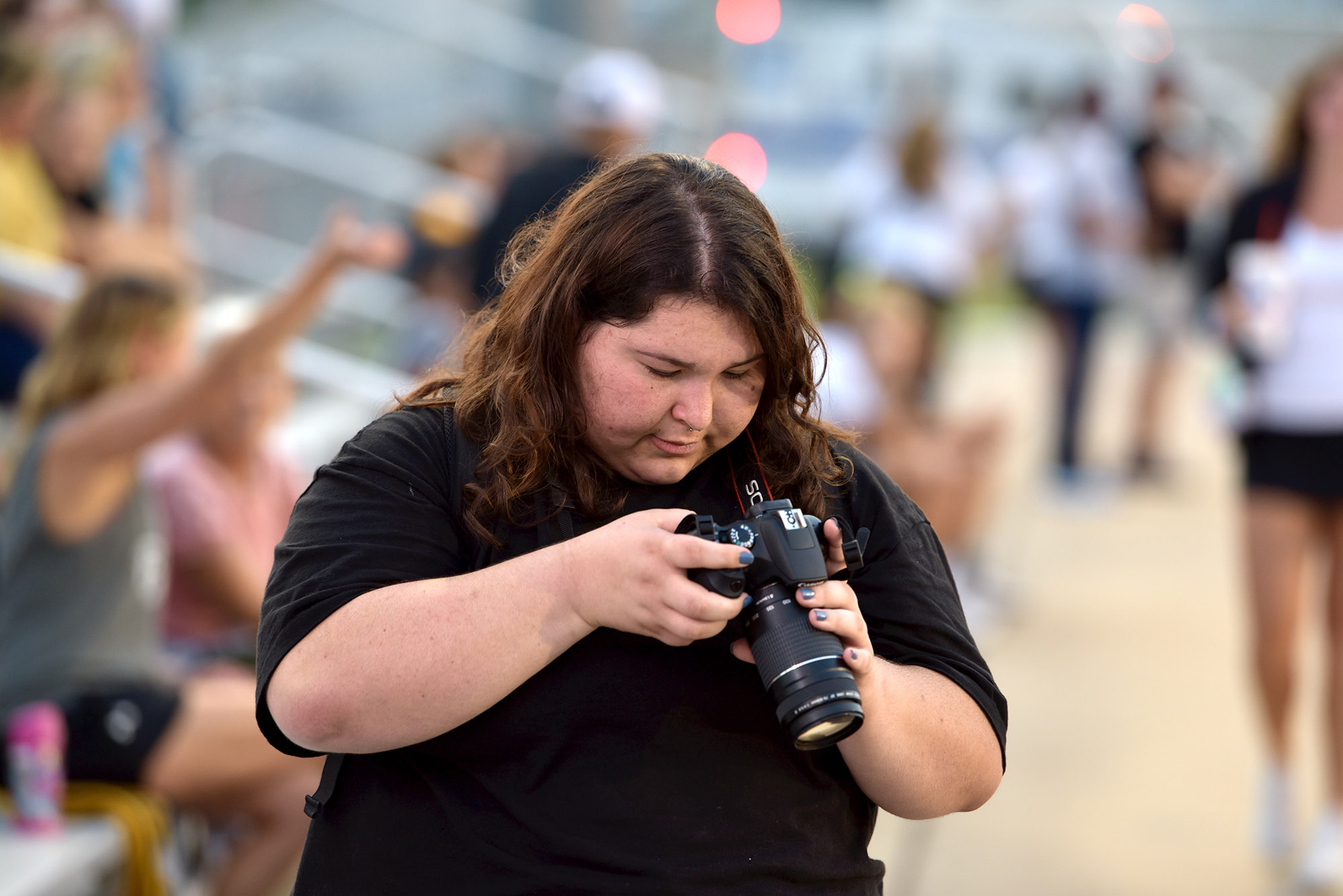 a student reviews photos during a football game