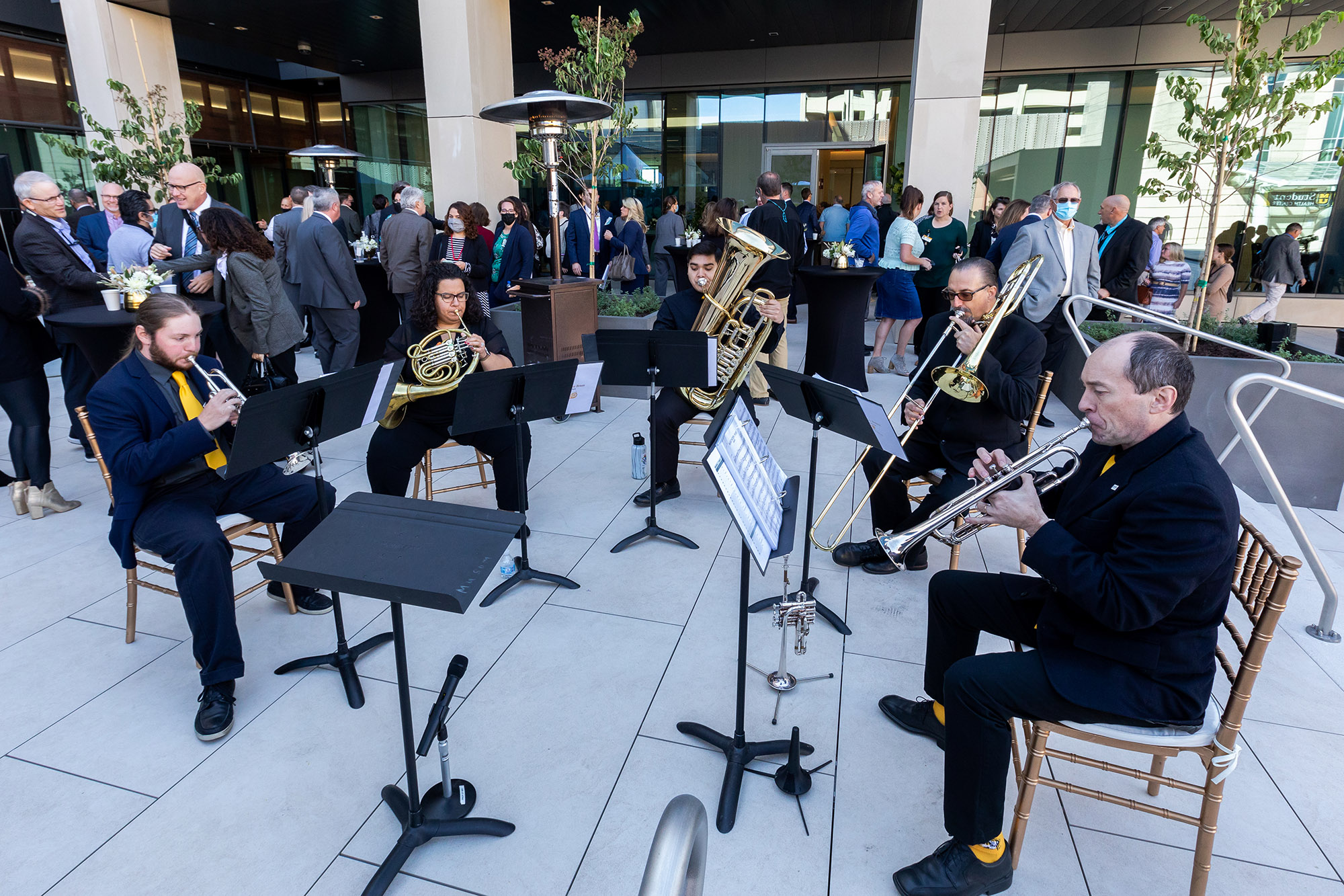 a brass quartet plays music outside at the event
