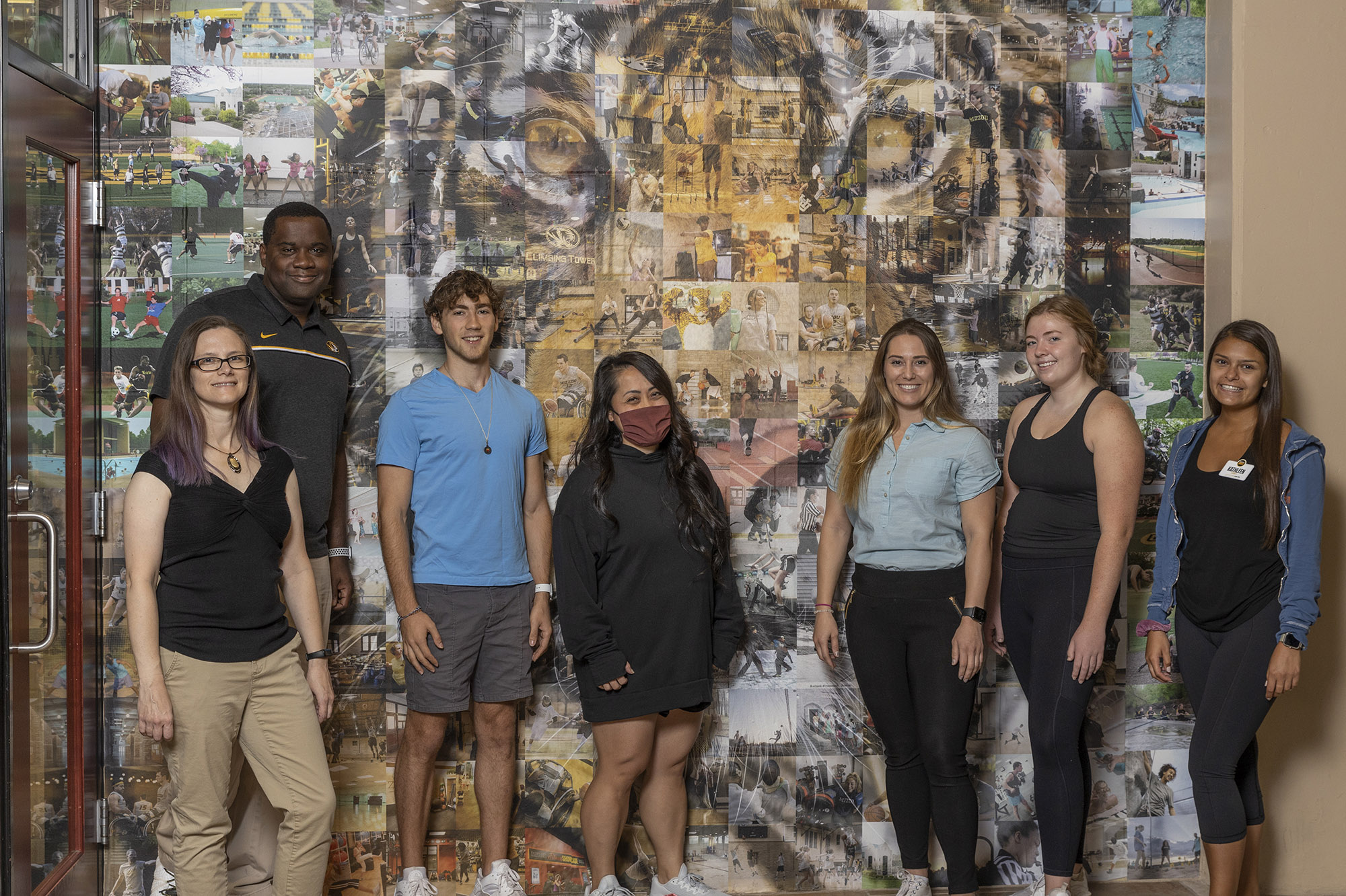 Division of Student Affairs employees and MizzouRec student staff pose in front of the tiger mosaic art installation in the MizzouRec