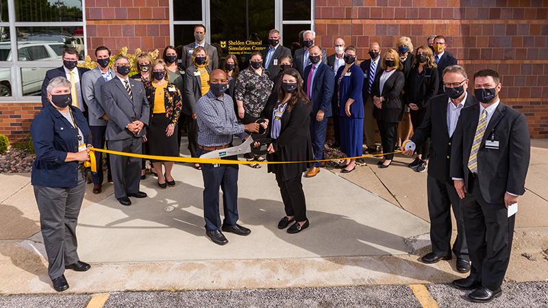 people outside at a ribbon-cutting ceremony