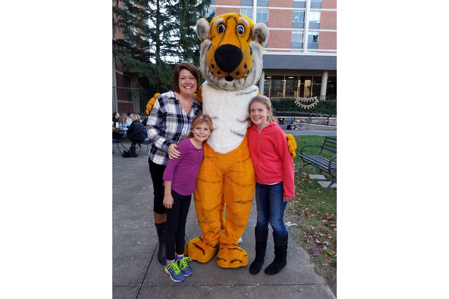 Megan Silvey and her daughters pose for a photo with truman the tiger