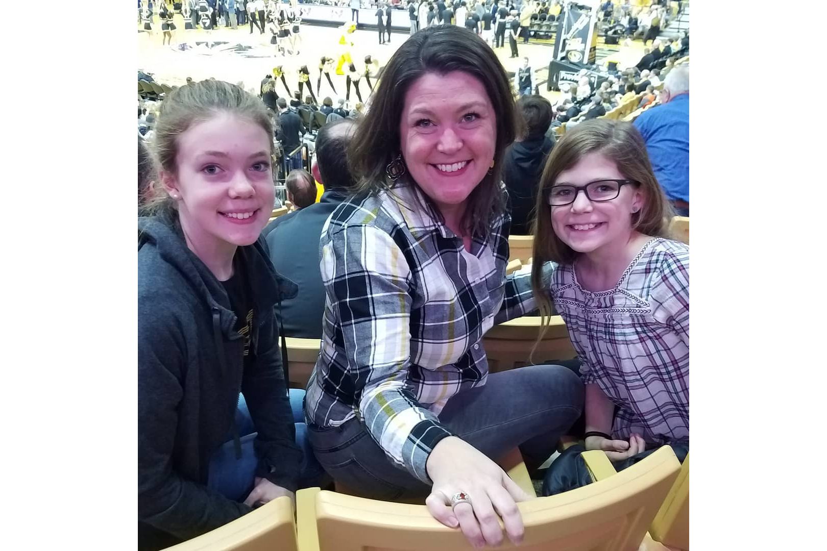 Megan Silvey and her daughters pose for a photo. They're at a Mizzou basketball game