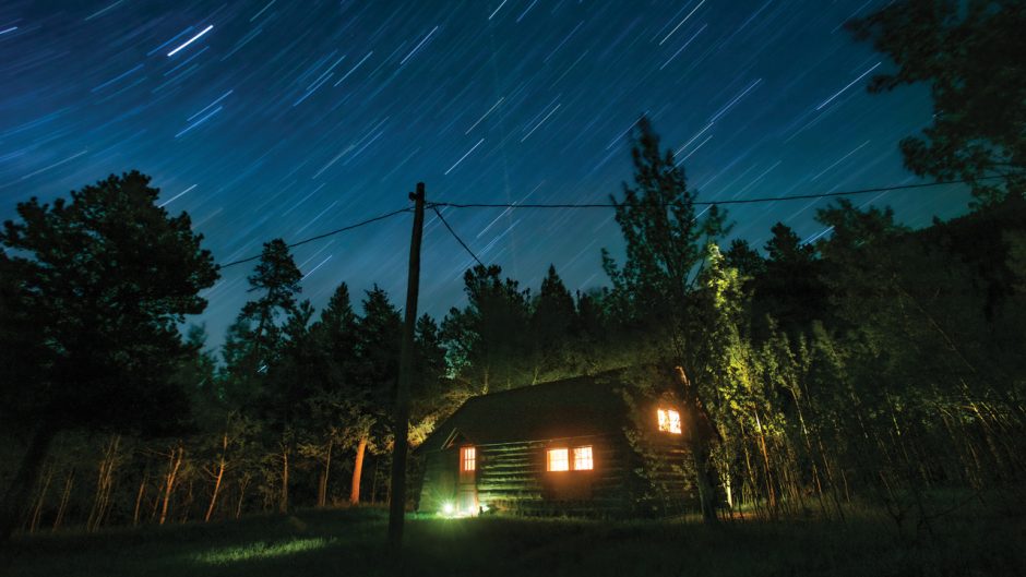 night shot of cabin under stars