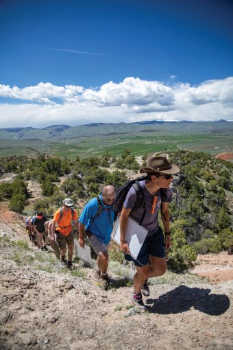 students following teacher on mountain hike