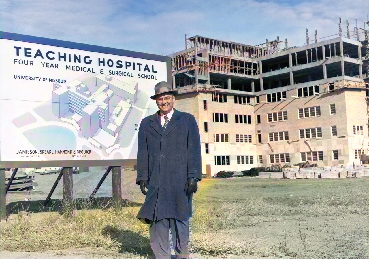 Dean Roscoe Pullen standing in front of University Hospital construction in 1954