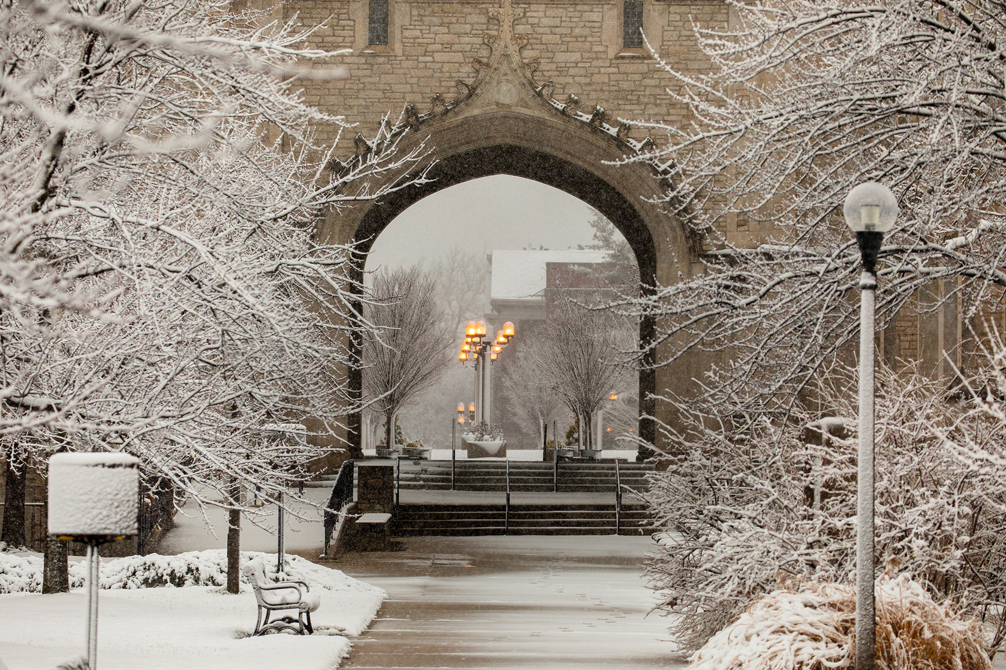 snow covers memorial union as we look through the archway