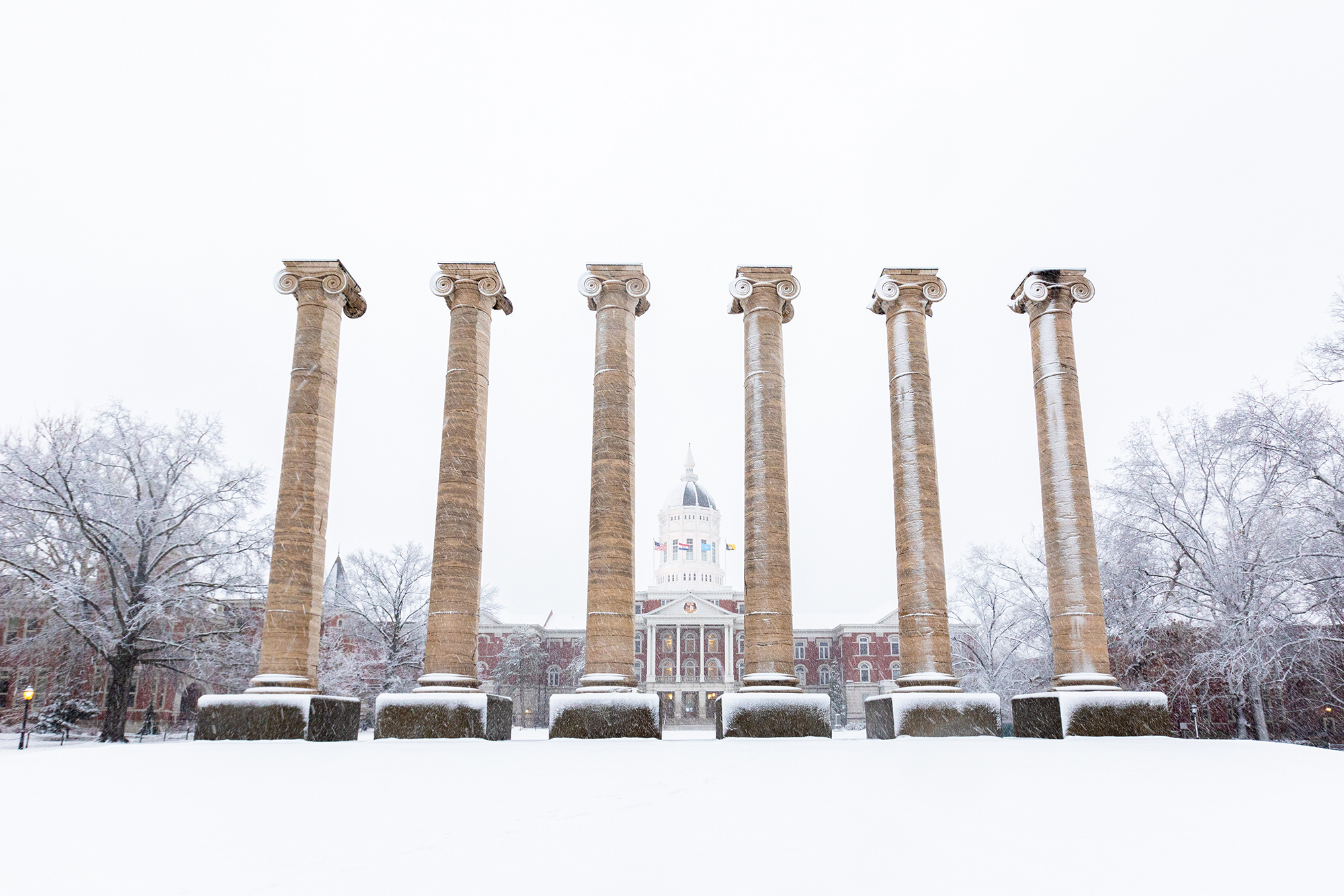 the columns covered in snow with hesse hall in the background