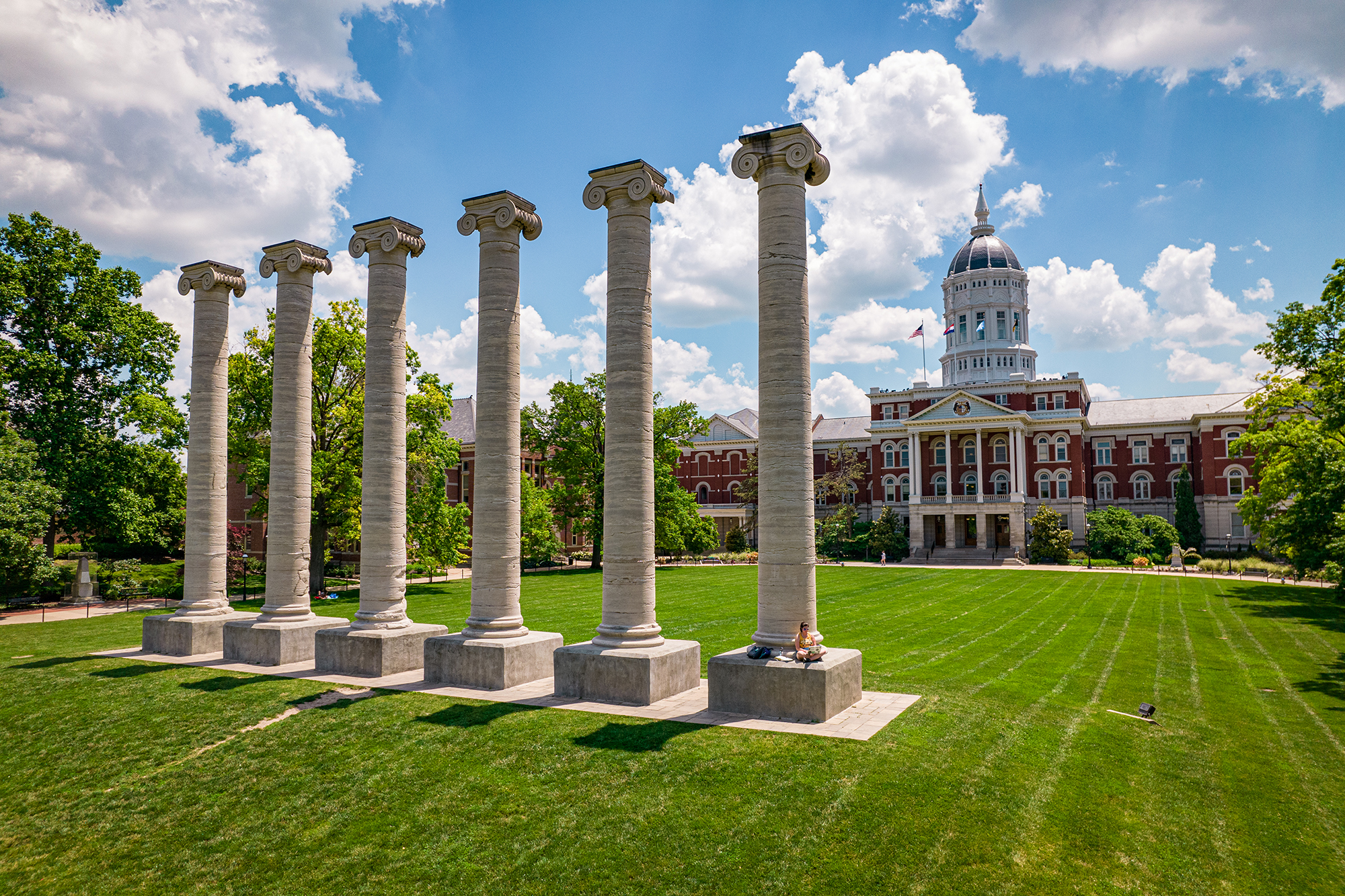 jesse hall on a sunny day with the columns in front of it