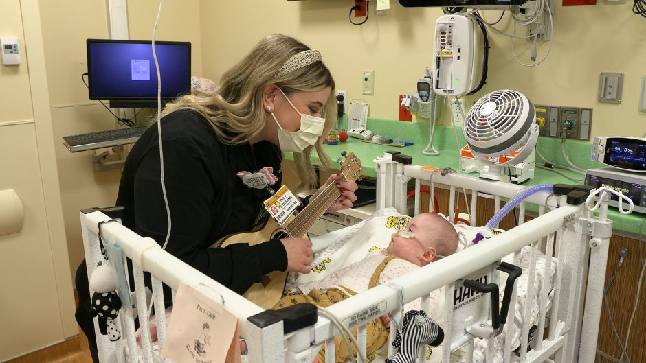 This is a photo of a nurse singing to a baby