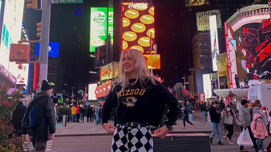Lexie Schrock in Times Square with a Mizzou sweatshirt on