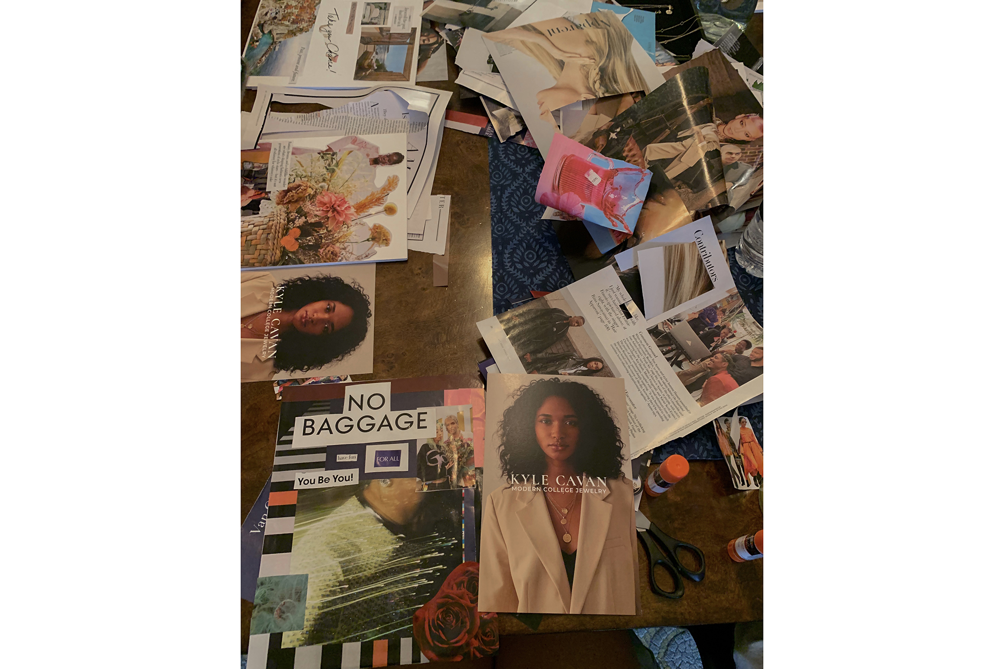 magazine clippings, scissors and glue on a wooden table